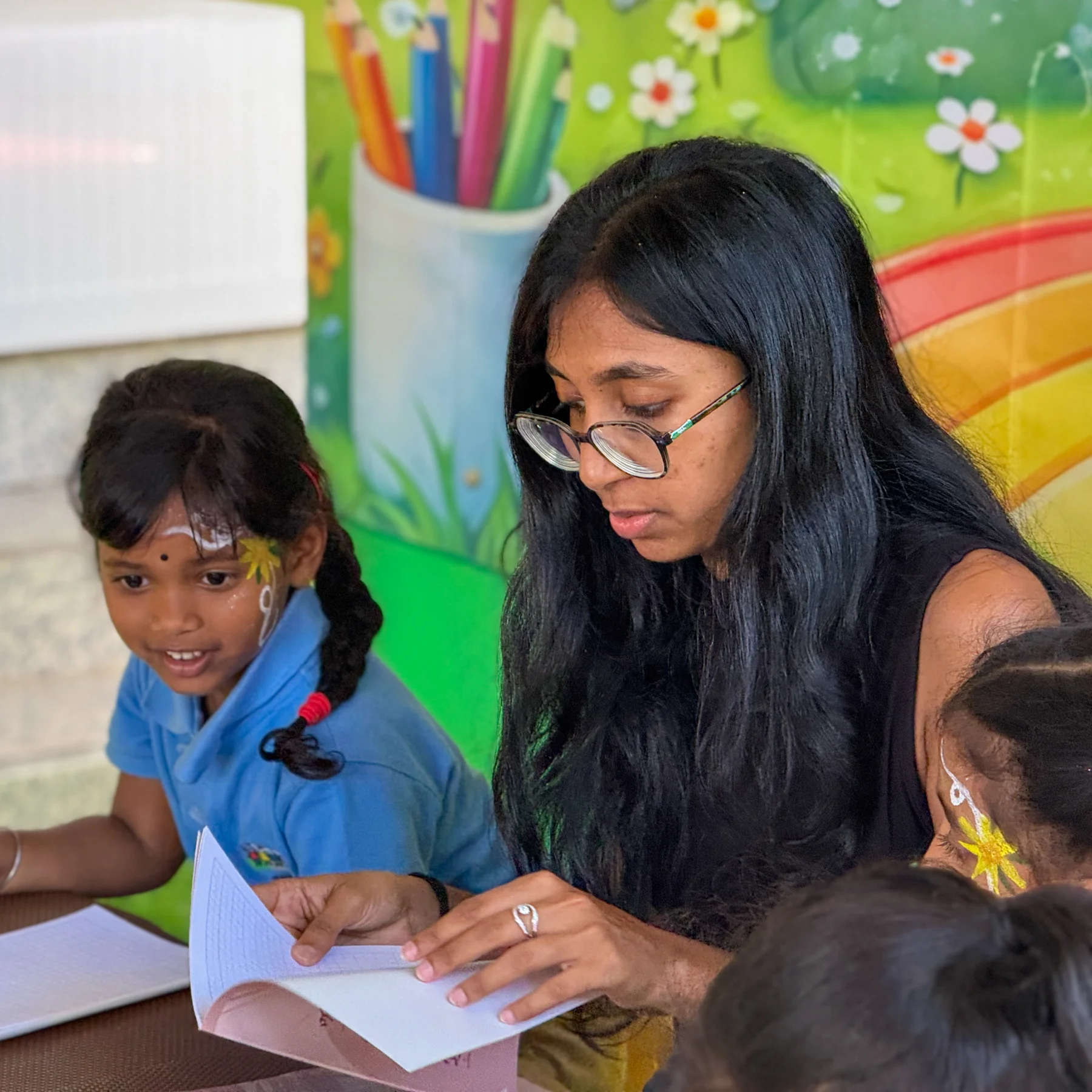 An educator sharing a book with children